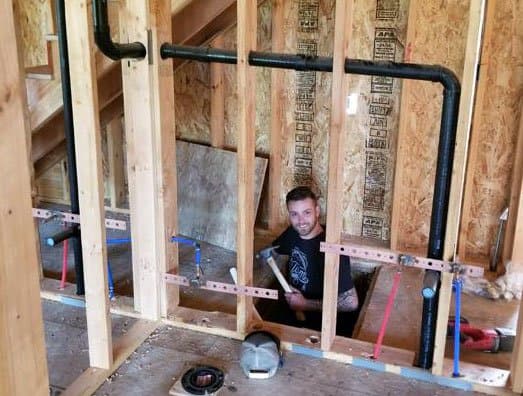 Red and blue PEX supply lines run through open wall framing