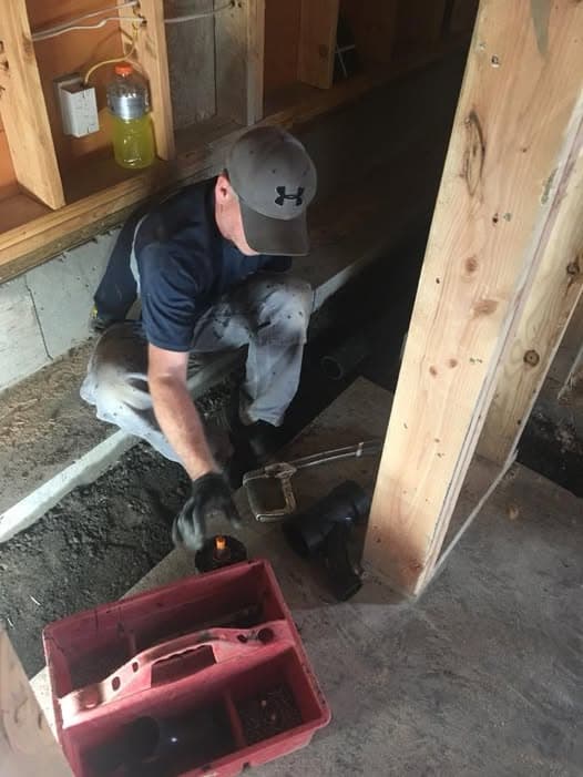 All County plumber working on toilet plumbing