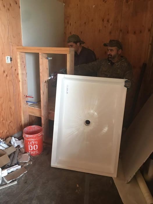 All County team installing a shower pan