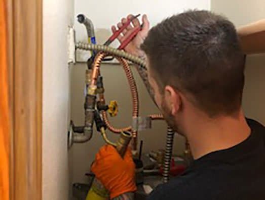 All County plumber working on water-heater connections